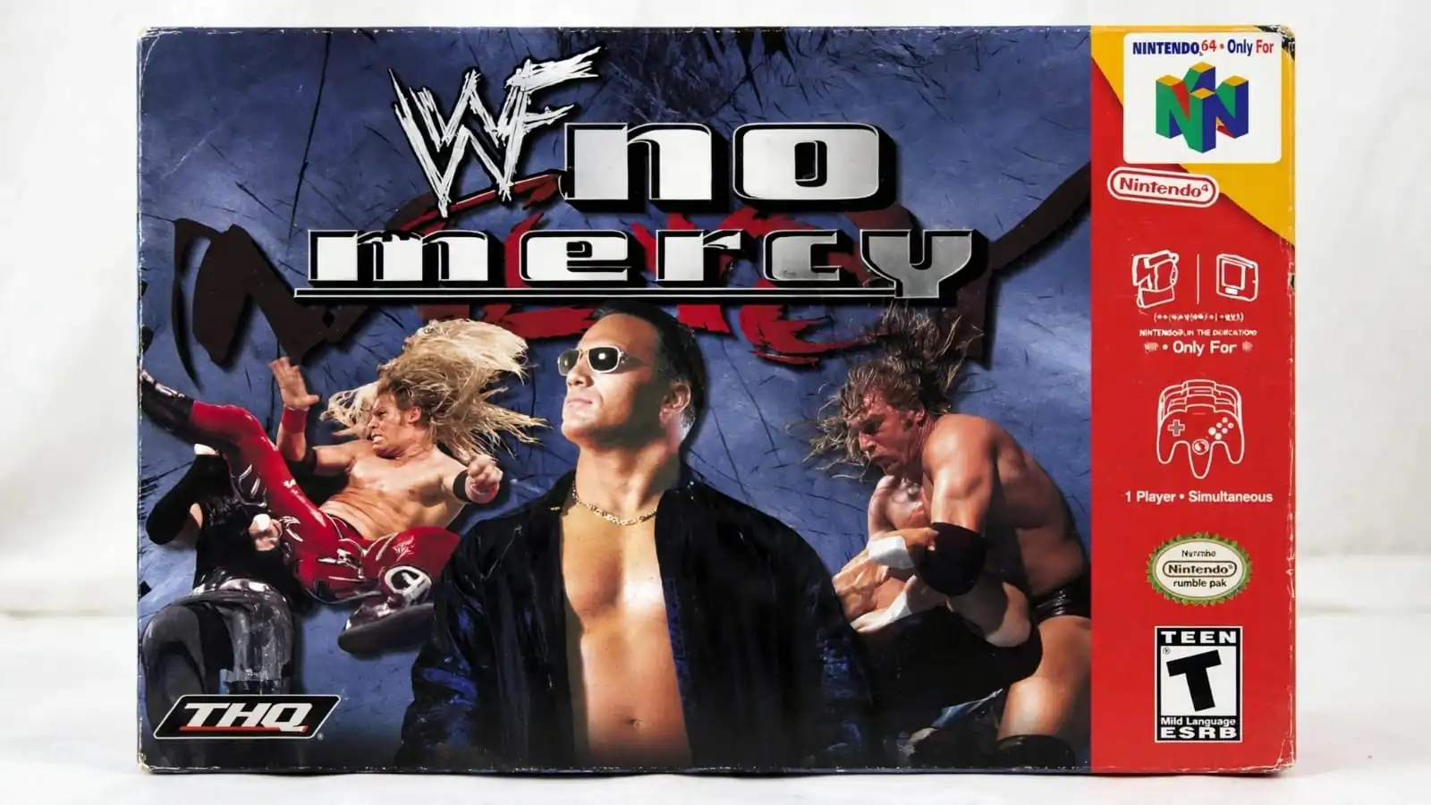 Professional wrestlers perform grappling moves and powerful attacks inside the wrestling ring in WWF No Mercy. The Nintendo 64 wrestling game features championship matches, character customization, and different match types.